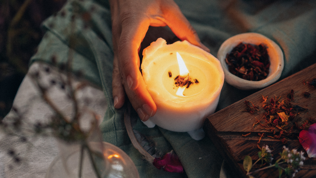 hand holding a lit candle