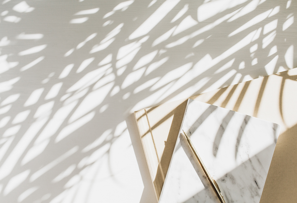 Notebooks with palm tree shadows over it