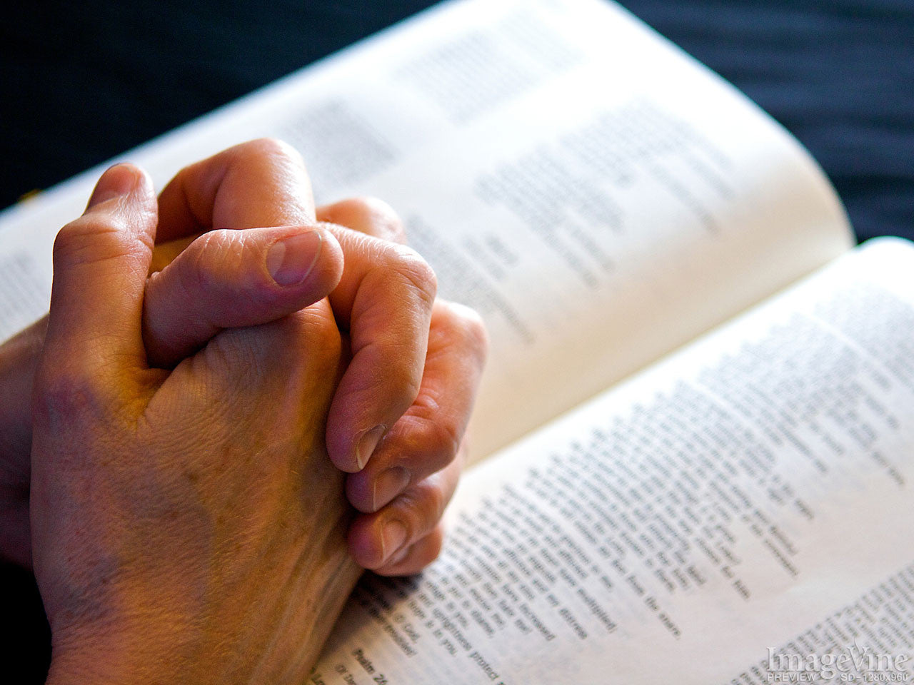 hands on a bible