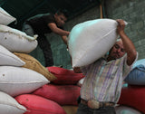 Fair Trade Farmer Workers Stacking Coffee