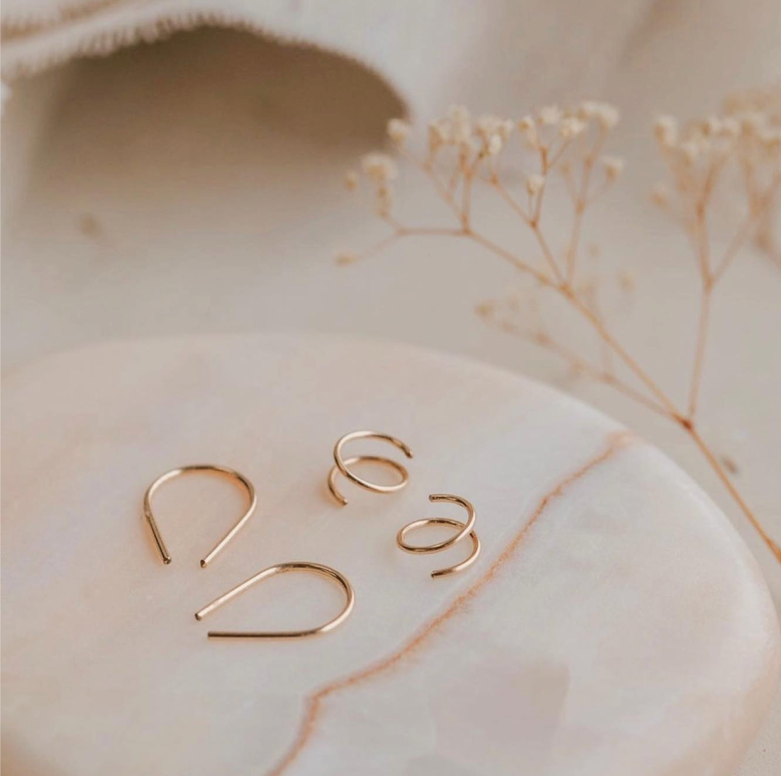 Hello Adorn's Tiny Horseshoe Earrings and Tiny Twists are best-sellers at Narrative + Co
