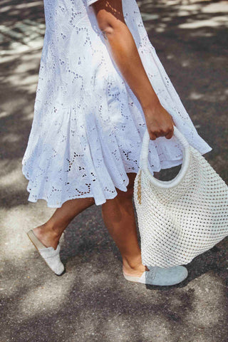 Dione in the BALLOU Eyelet Dress and the VARLET Bag in Ivory