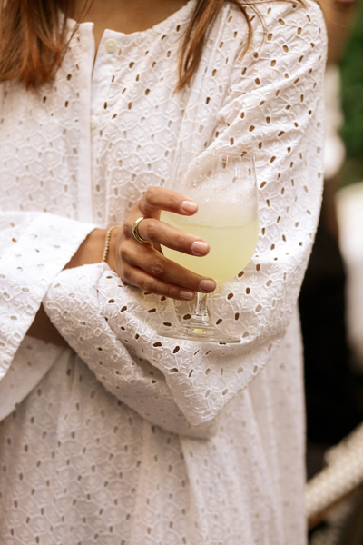 Woman in Vlieland Dress holding cocktail