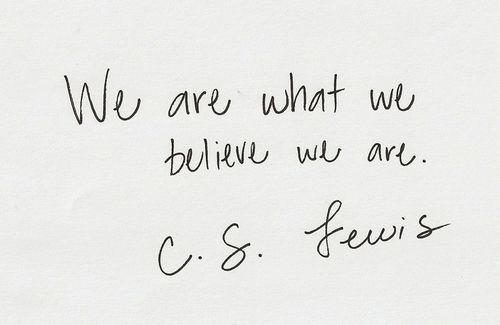 Handwritten C.S. Lewis quote "we are what we believe we are."