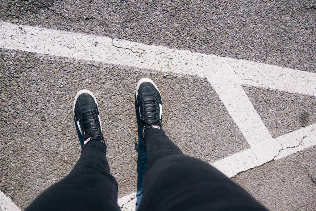 Shot of legs wearing Vans high tops in a parking lot.  Shoppe 815 - Scents of Adventure