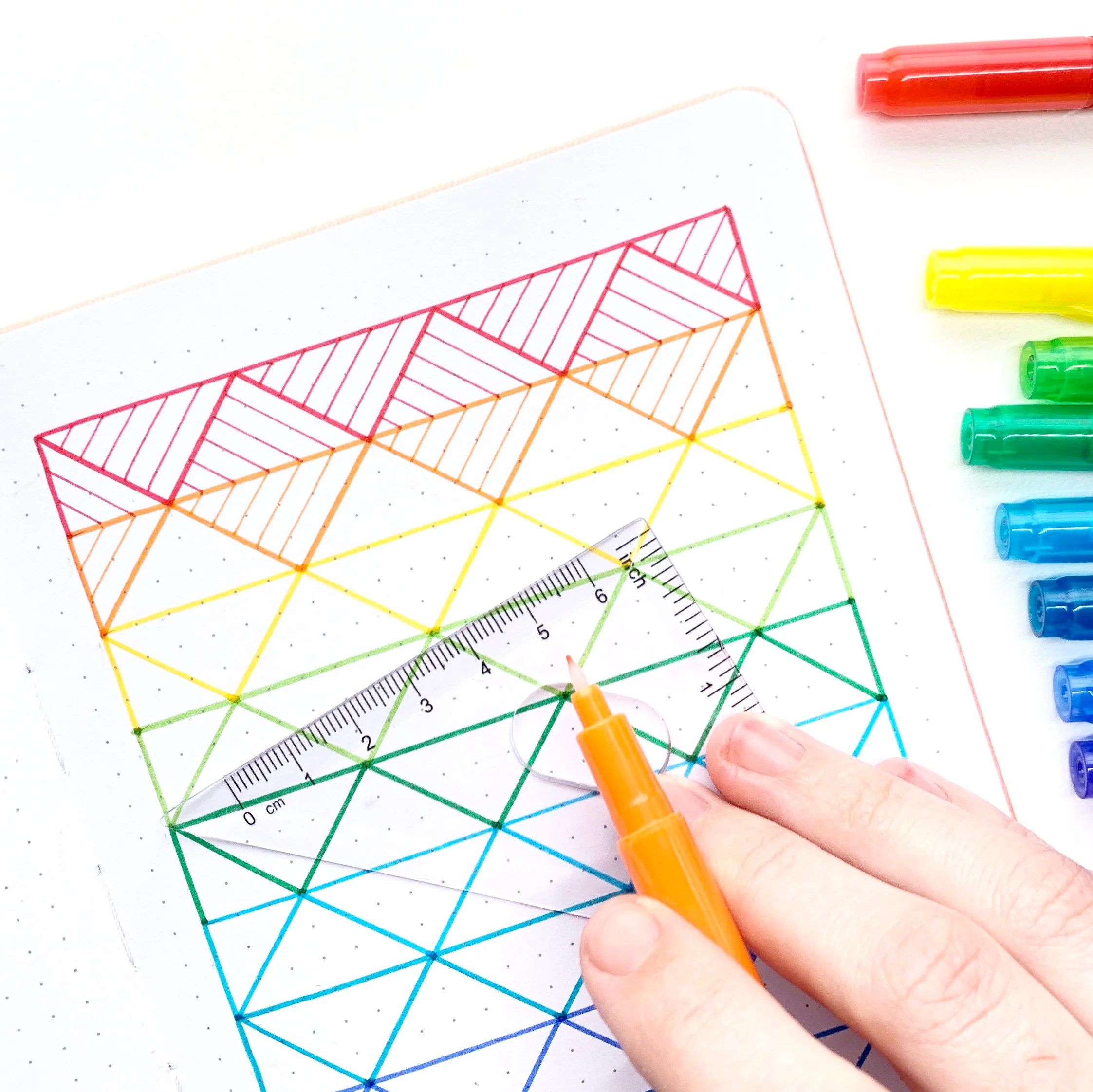 Learn how to create a rainbow pattern in your dot grid notebook with Adrienne from @studio80design