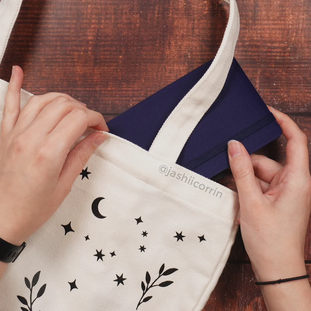 Putting notebook into tote bag