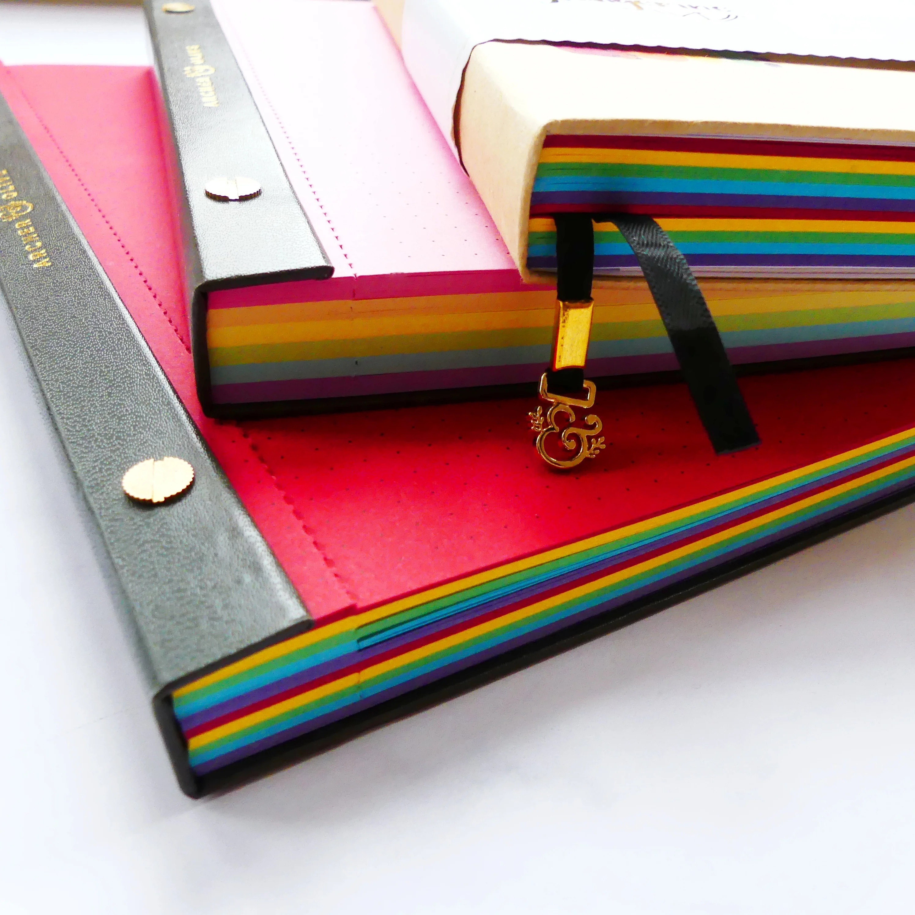 Stack of coloured notepads and a journal