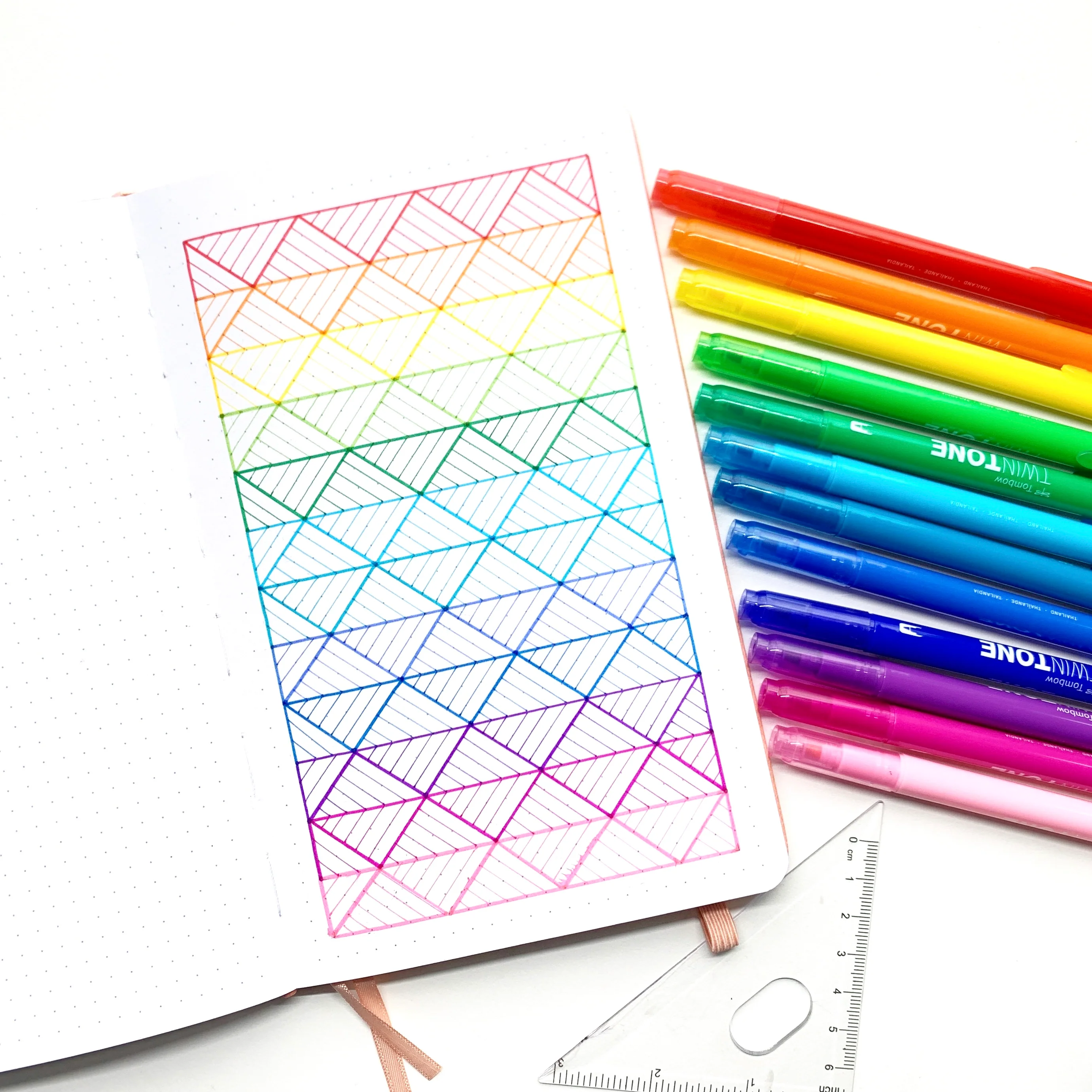 Learn how to create a rainbow pattern in your dot grid notebook with Adrienne from @studio80design