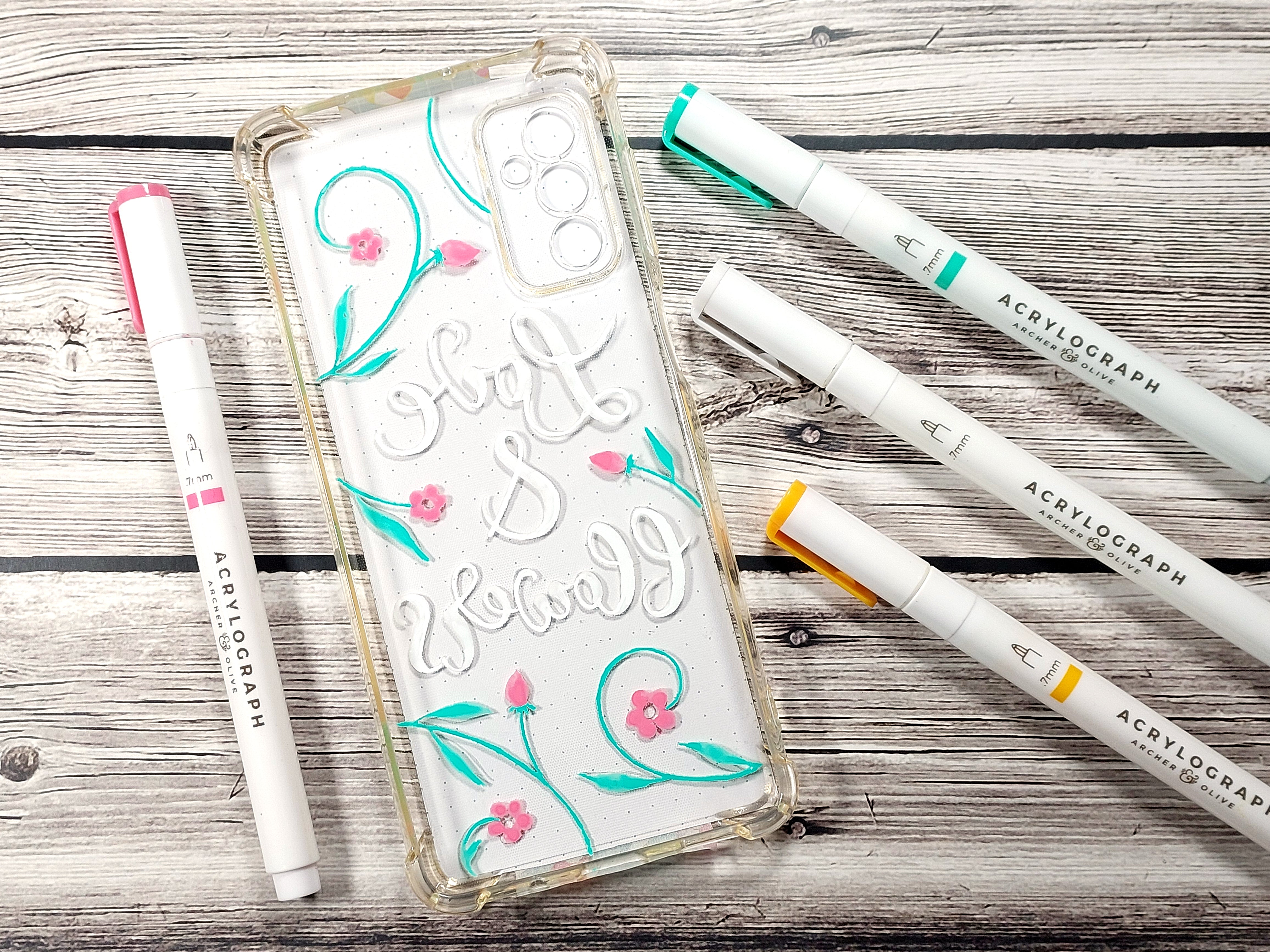 Lettering, stems and petals painted on the phone case