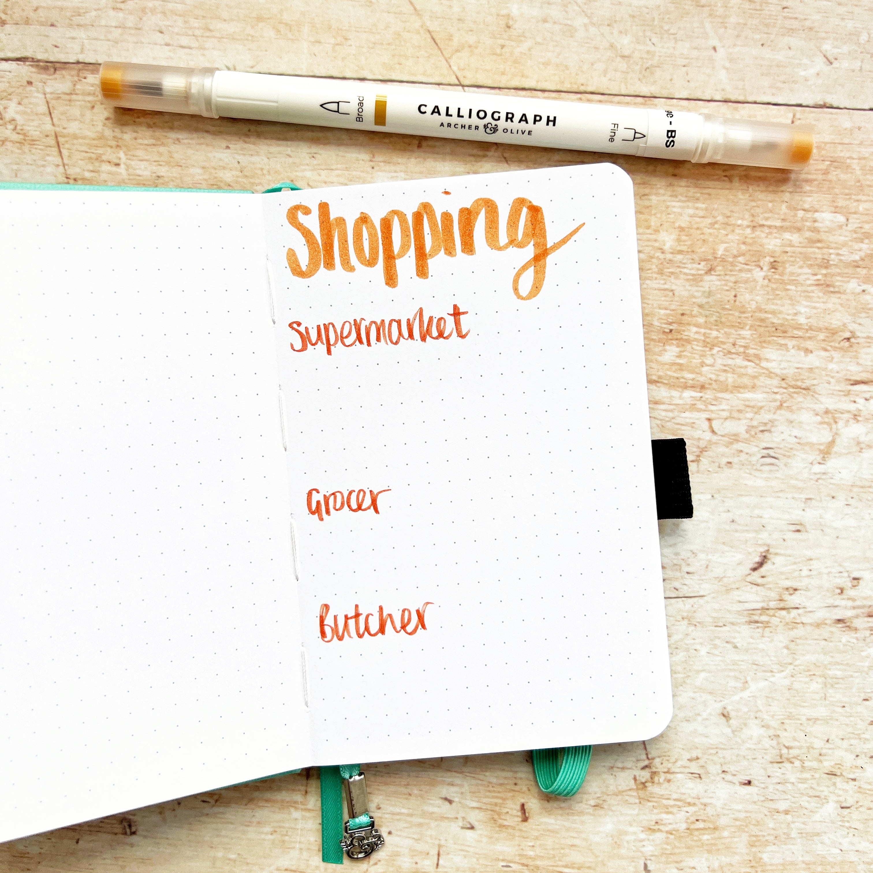 A6 open showing a shopping list with pen