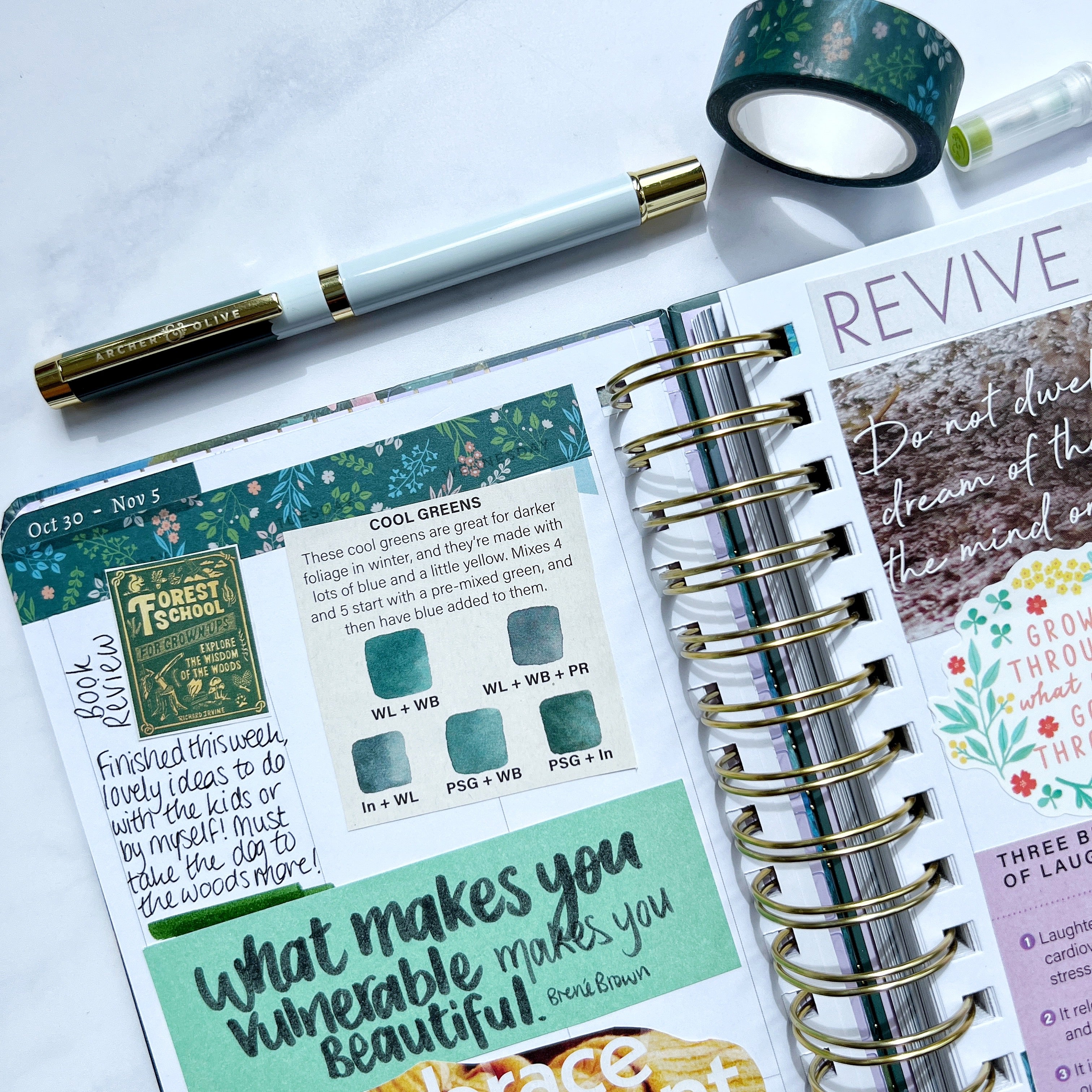 Open planner filled with quotes, magazine cuttings and stickers plus pen and washi tape