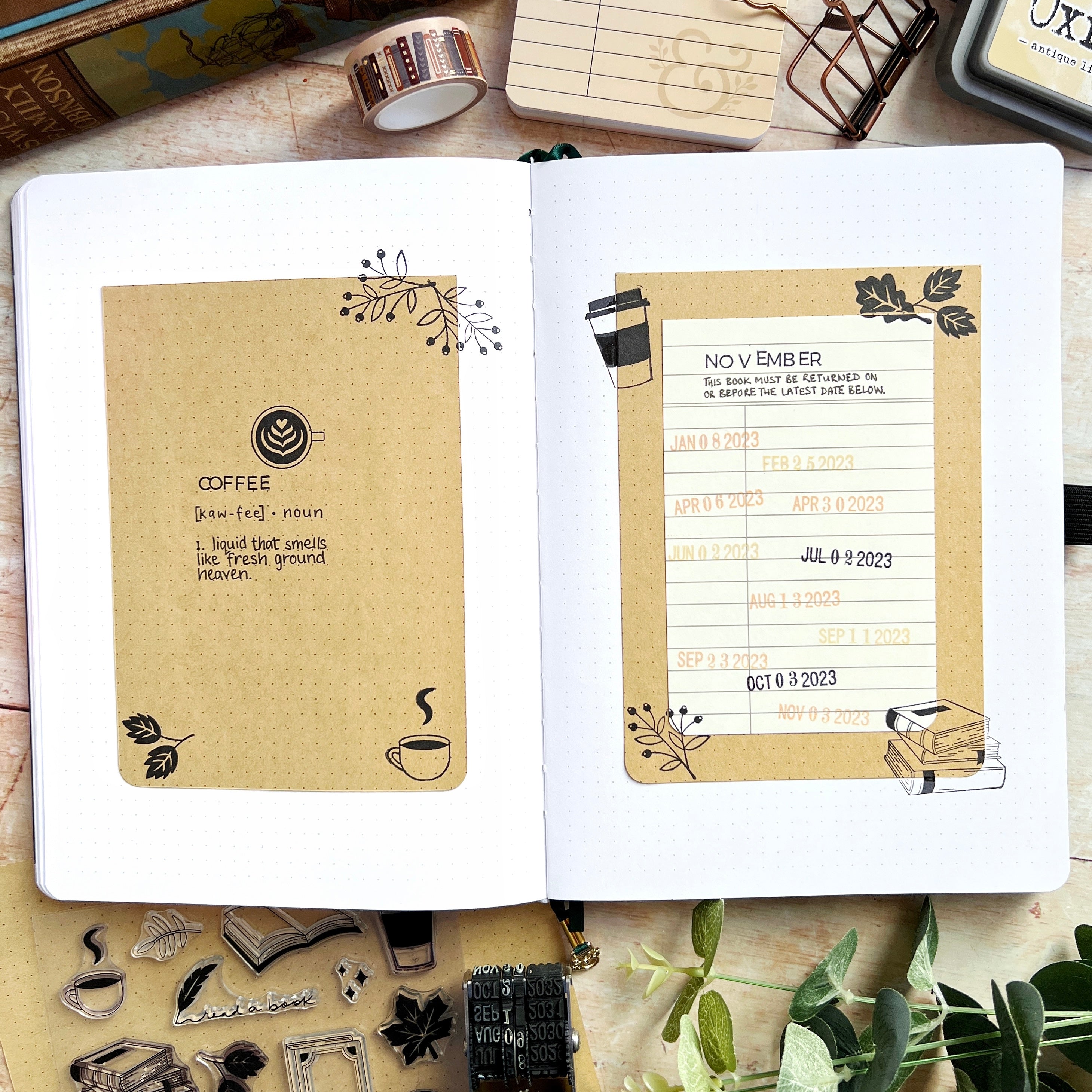 Open journal with November cover page using Kraft paper and ink stamps of books and coffee