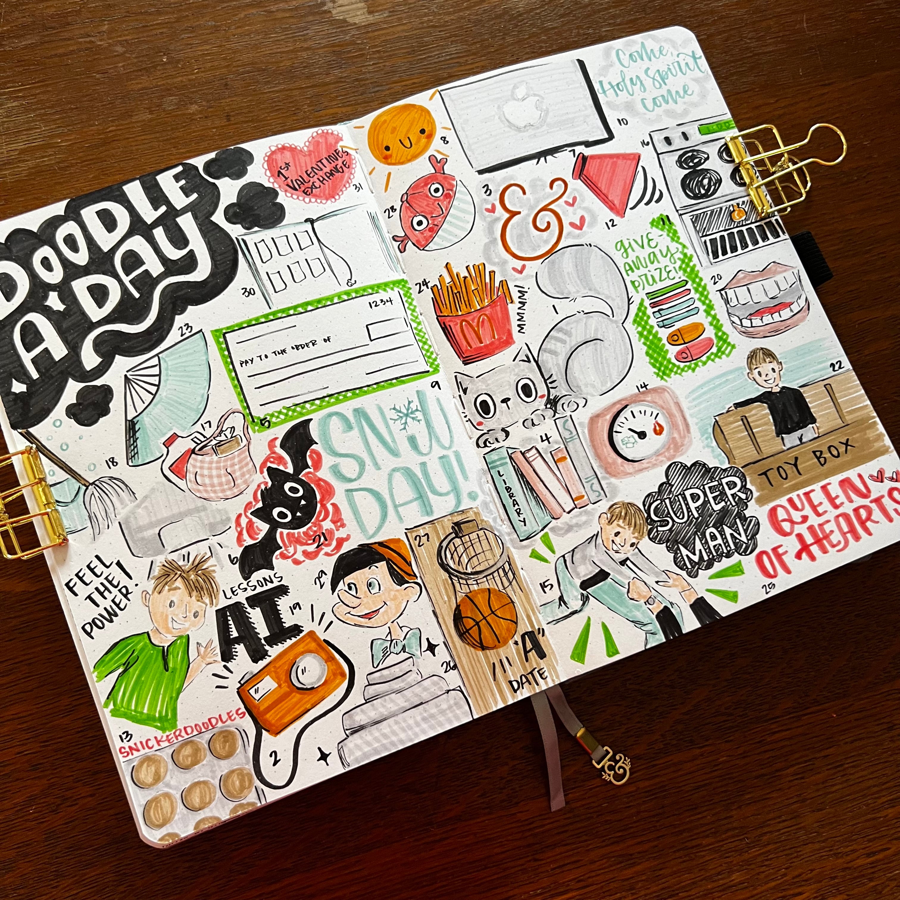 Open notebook with completed Doodle A Day collage style spread.