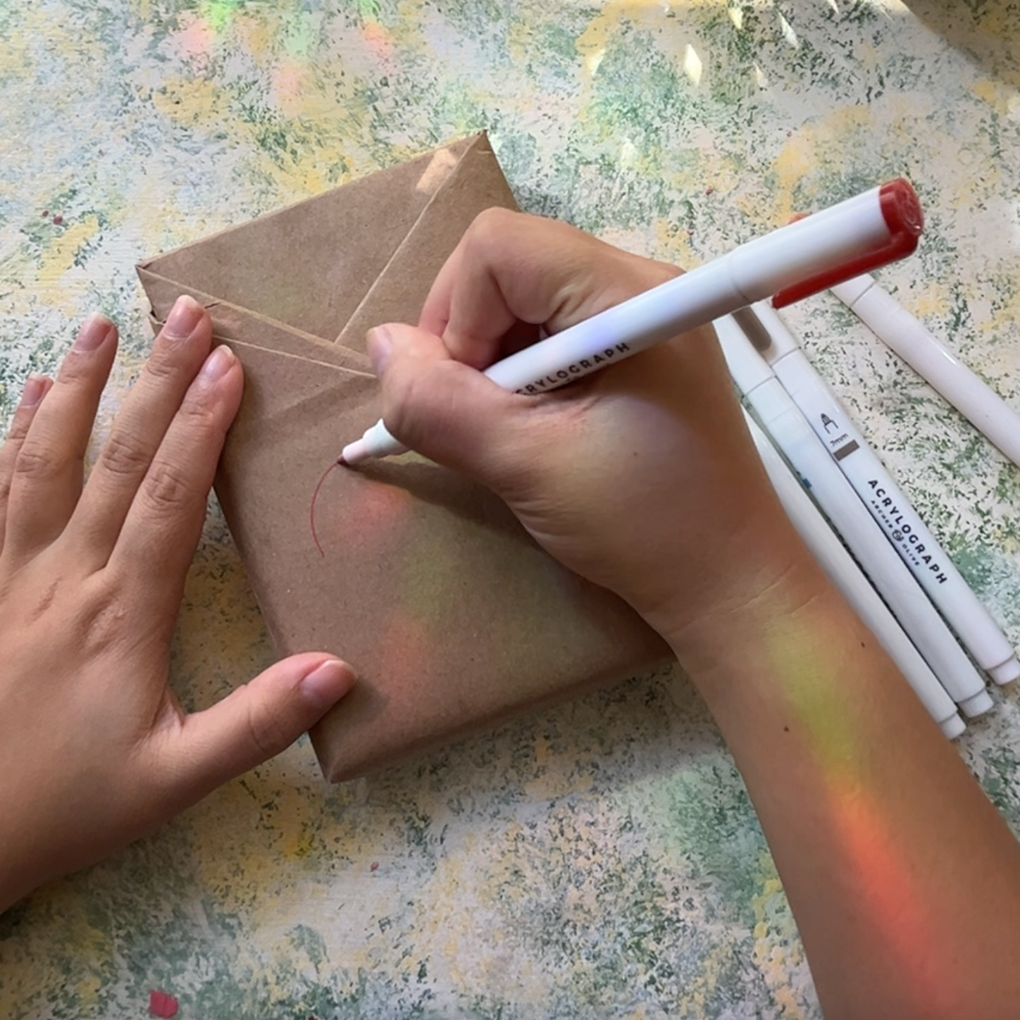 Doodle on the wrapping paper with Acrylograph pens
