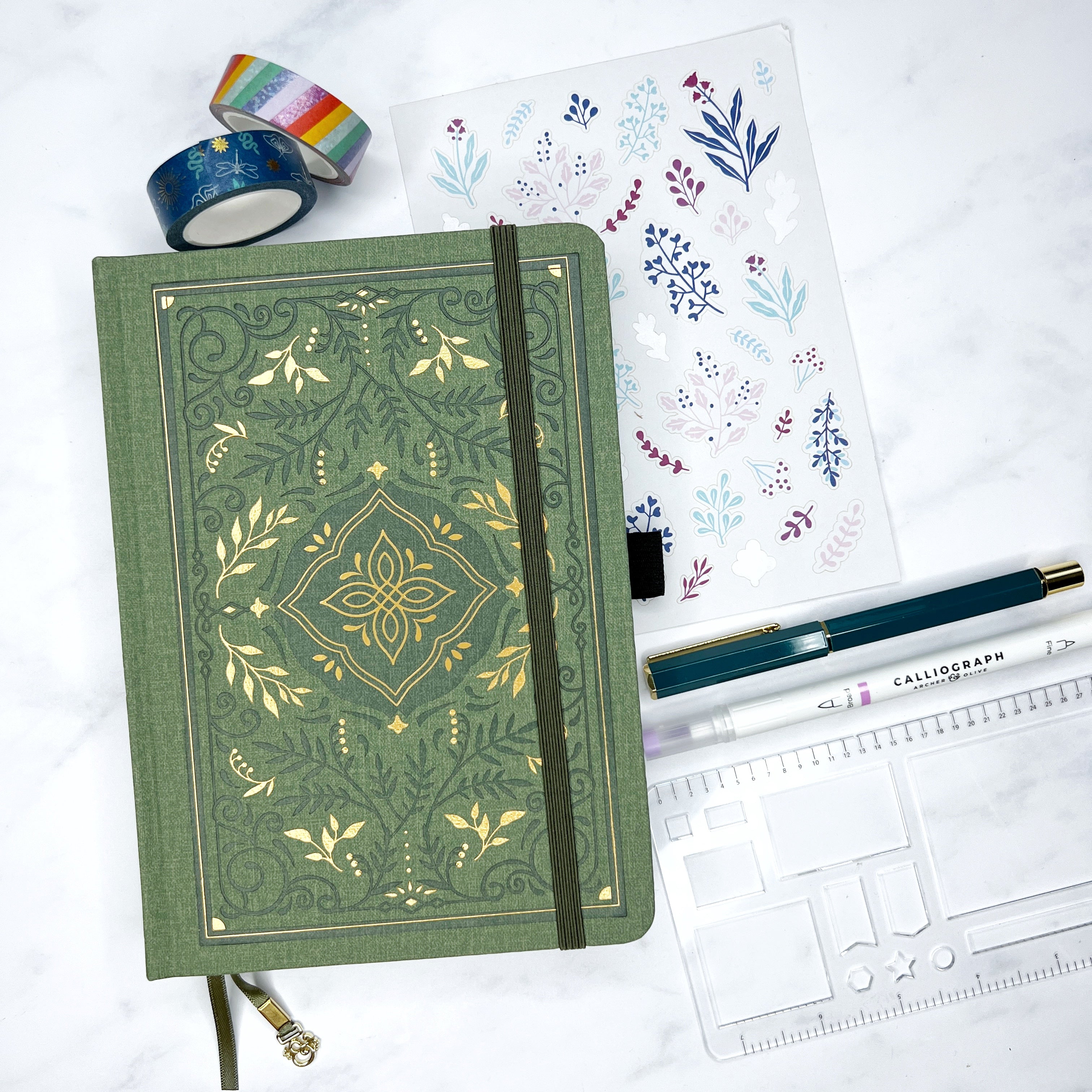 Closed green storybook journals with accessories
