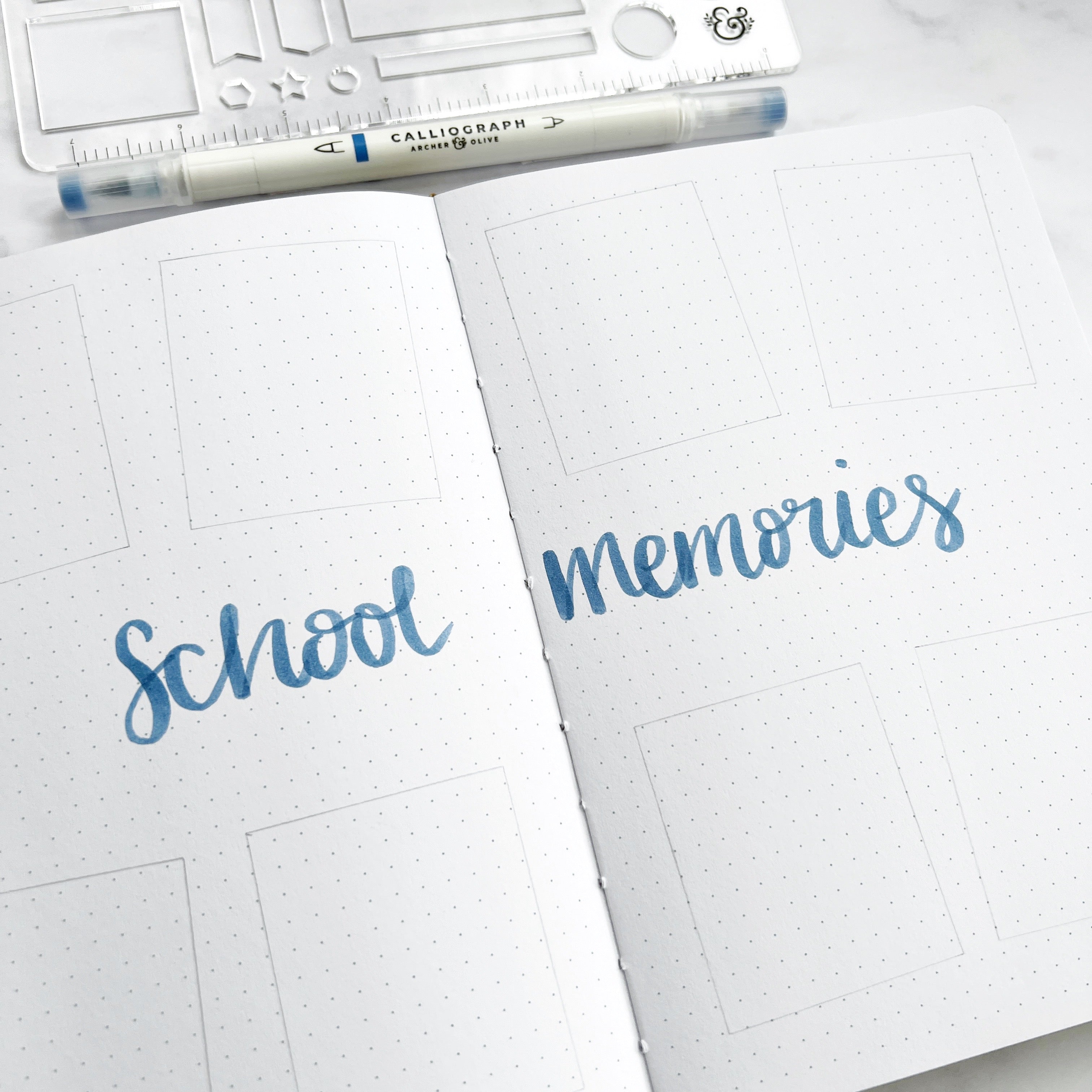 Double page open with title ‘school memories’ and pen plus stencil