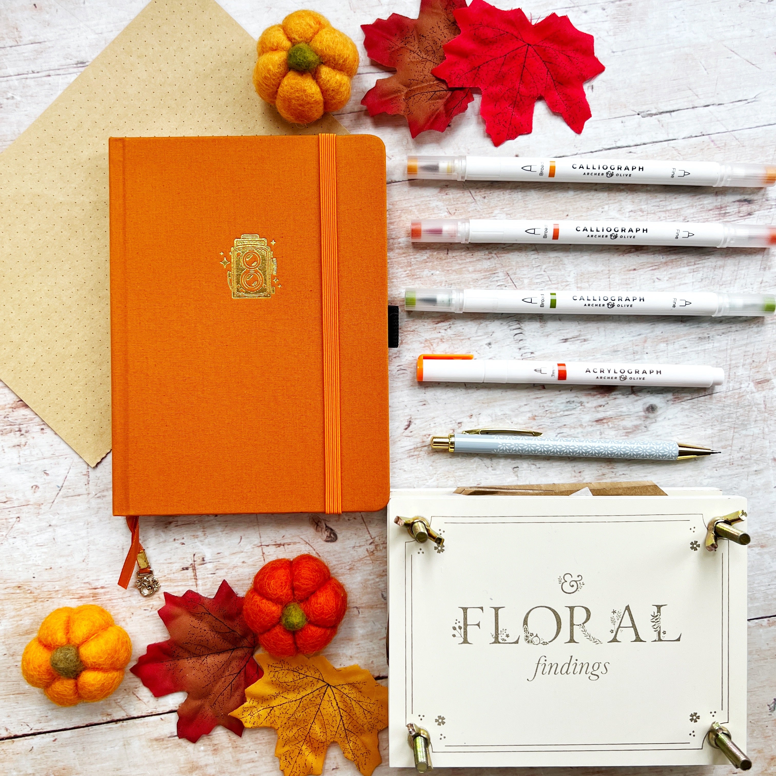 Orange journal pens and flower press