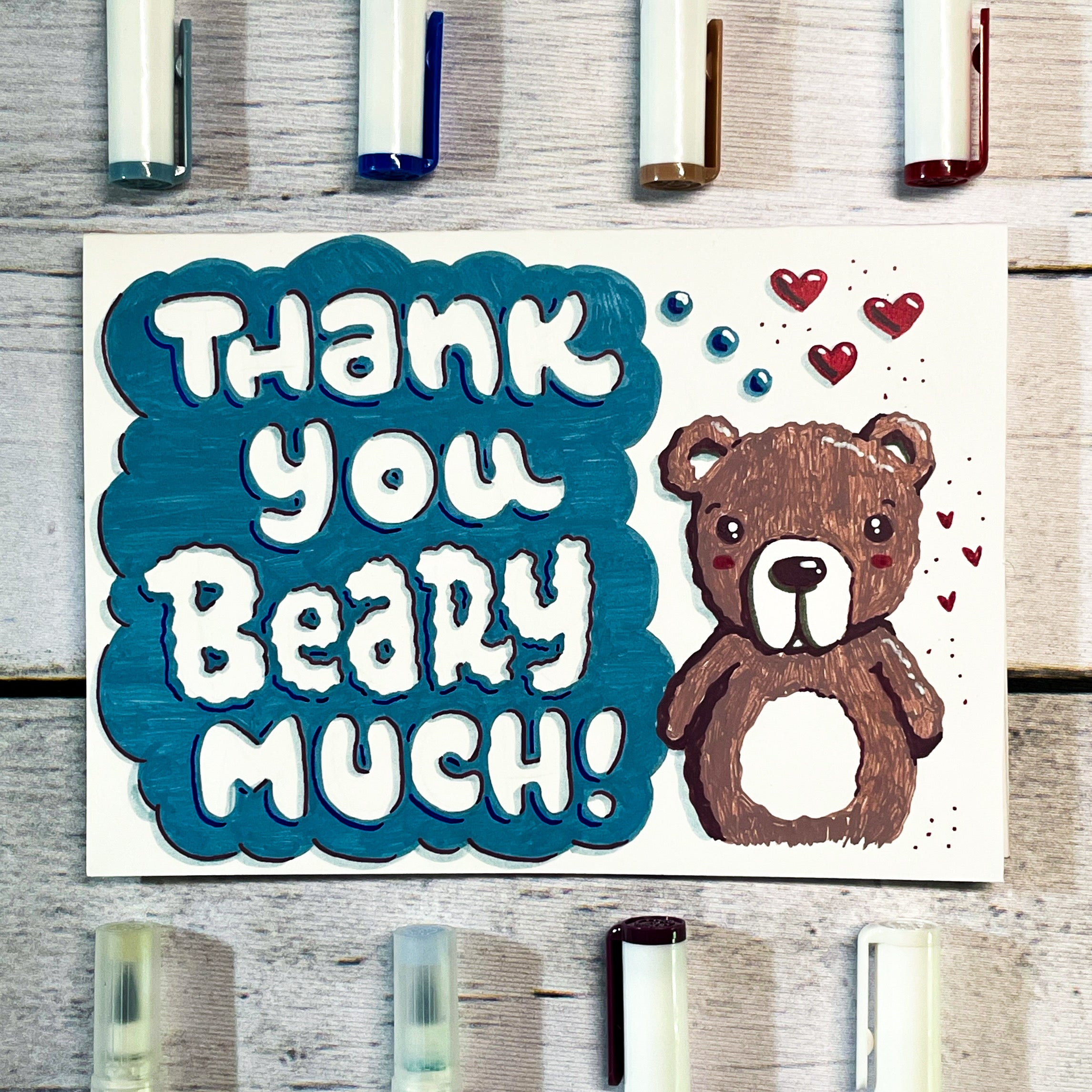 finished card design for "thank you beary much" with bear doodle and surrounded by archer and olive acrylographs and calliographs