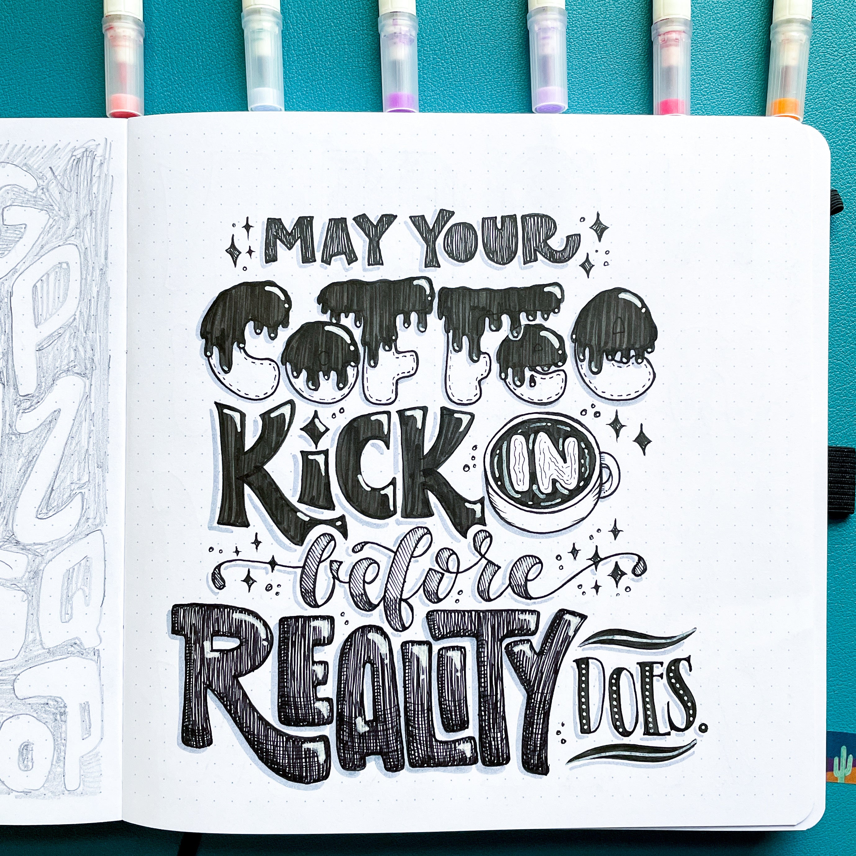 image of hand lettered quote "may your coffee kick in before reality does" on dot grid paper with calliograph brush pens