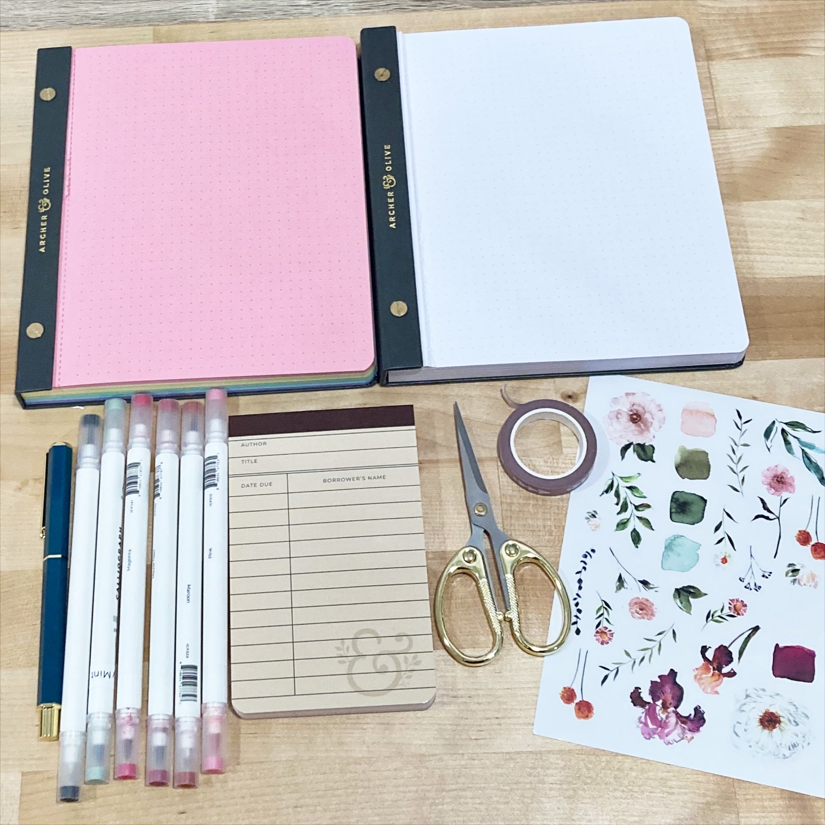Paper pads, calliographs, scissors, washi, and stickers used in this project.