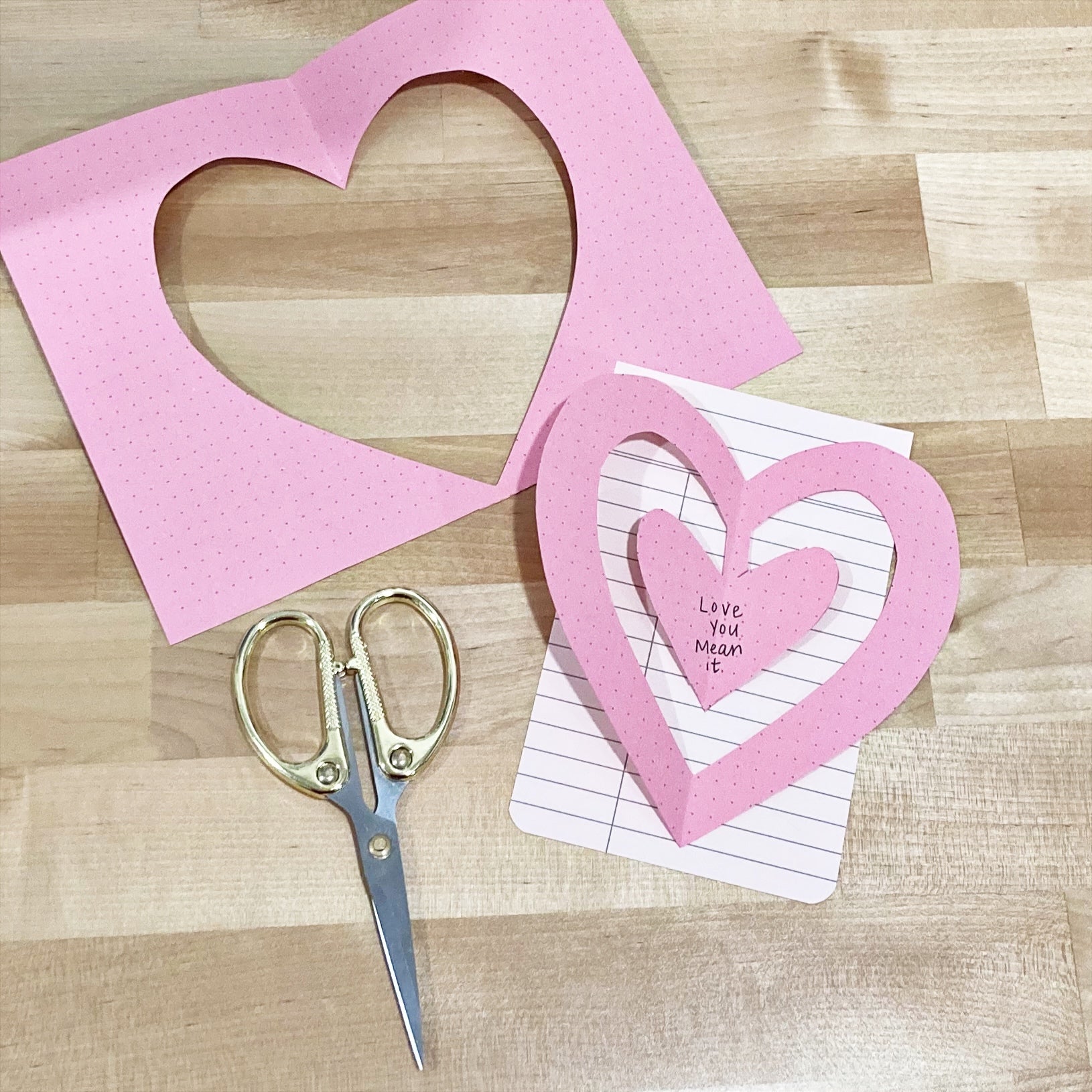 Two nested hearts cut out of paper