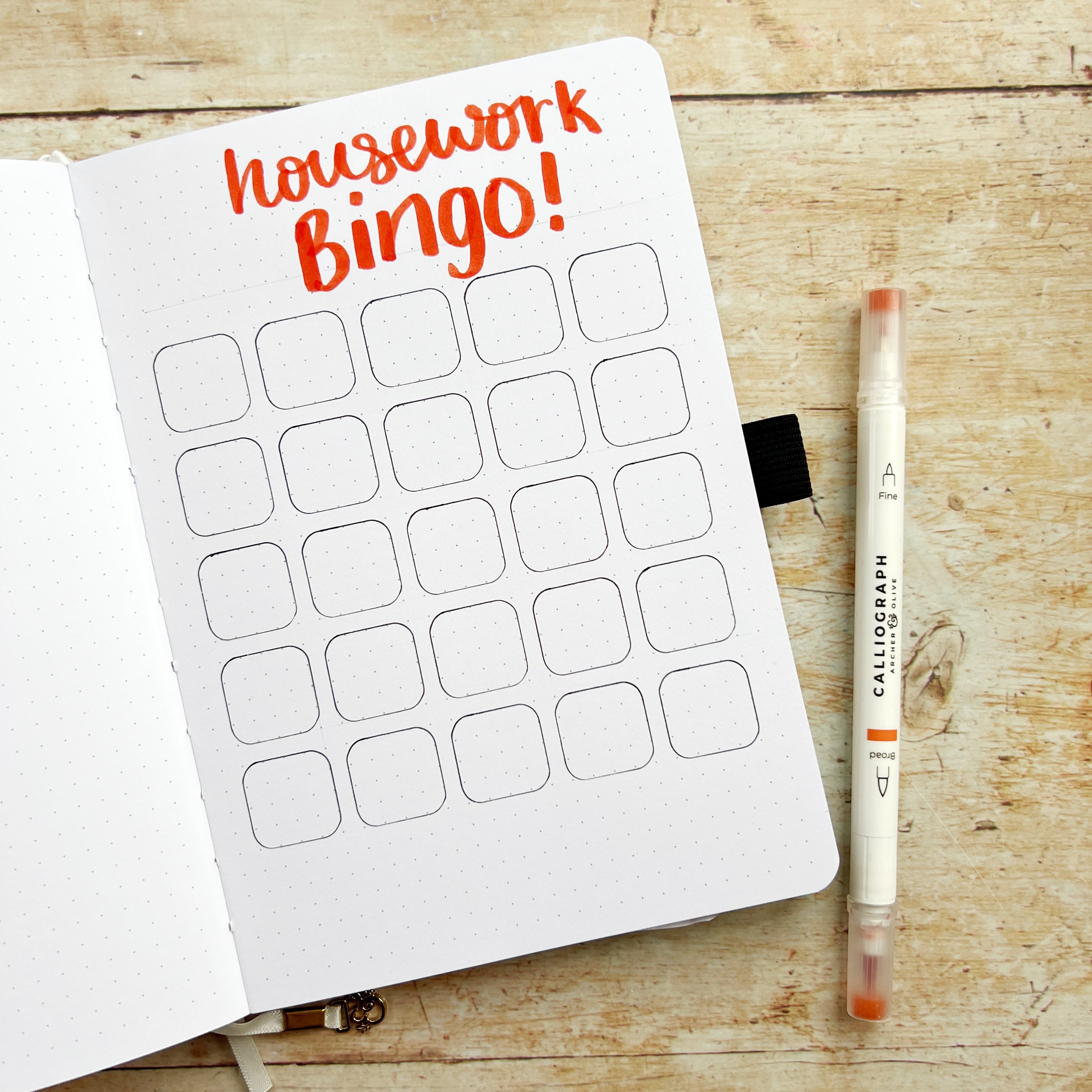 housework bingo header in open journal with 25 squares