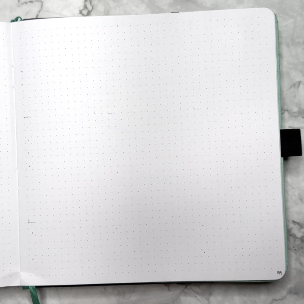 square bullet journal page with pencil marks for spacing
