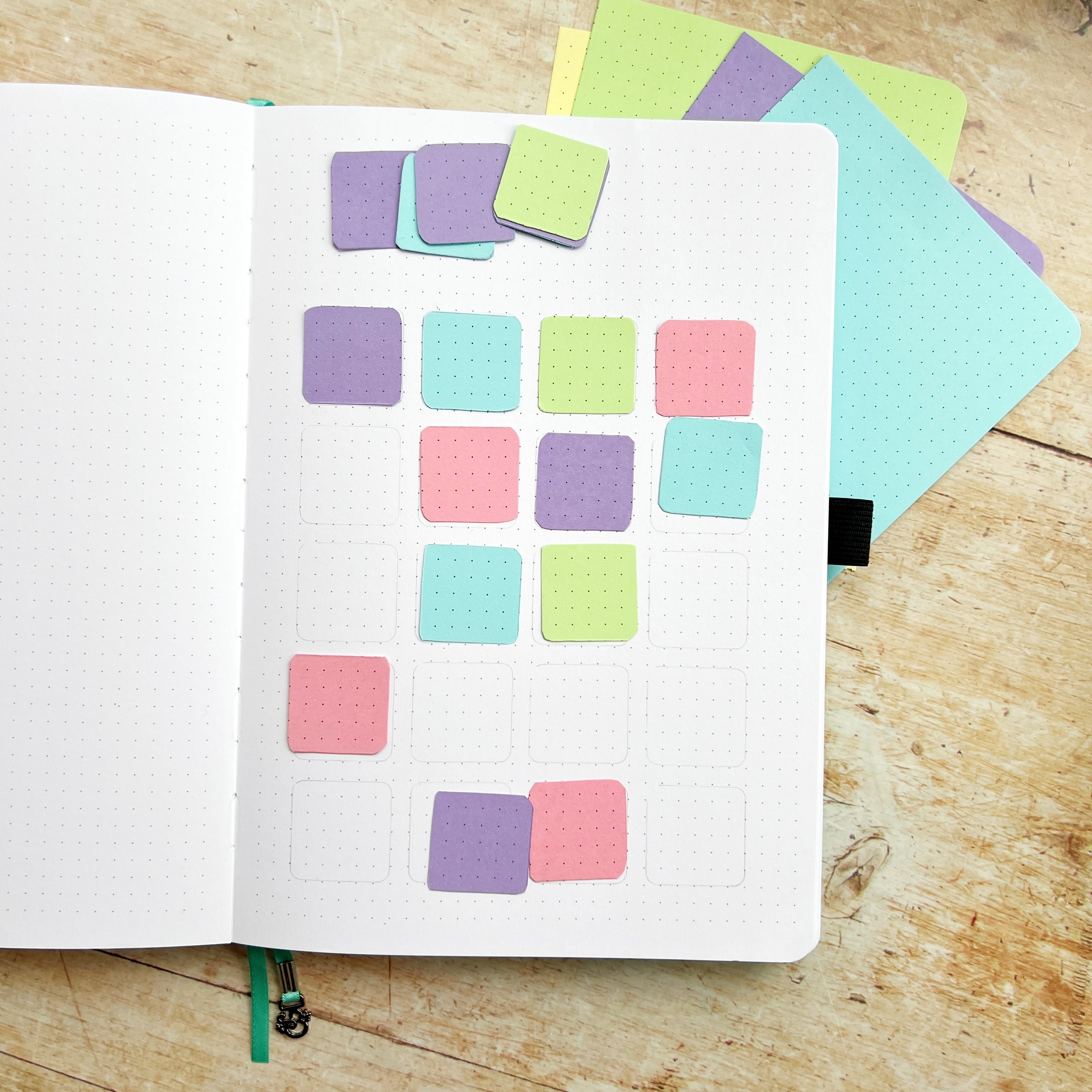 coloured paper squares on open journal page