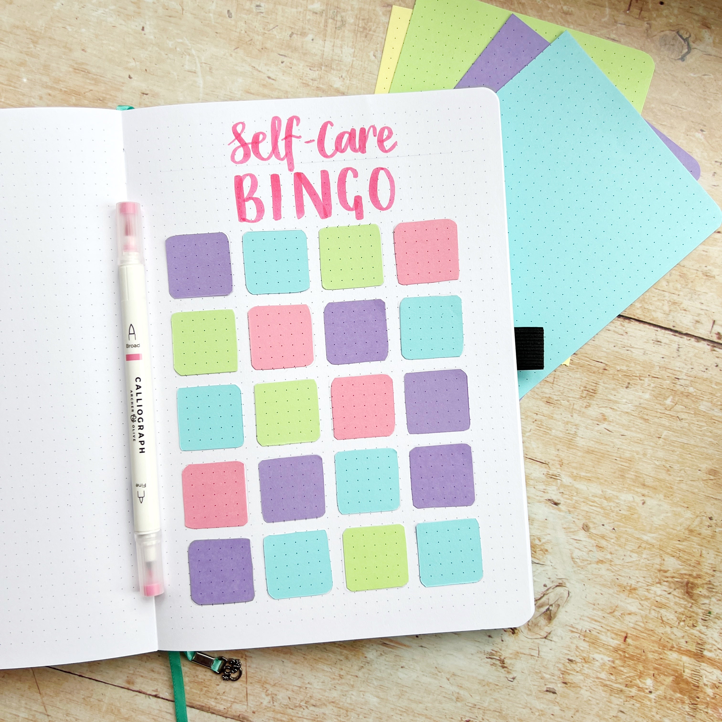coloured squares stuck in place on open journal page with header ‘self- care bingo’