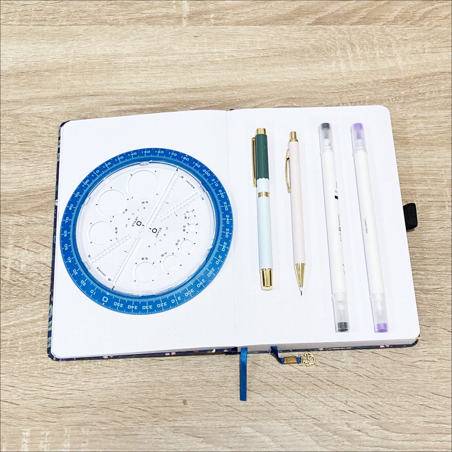 Notebook, calliographs, pen, pencil, and circle maker