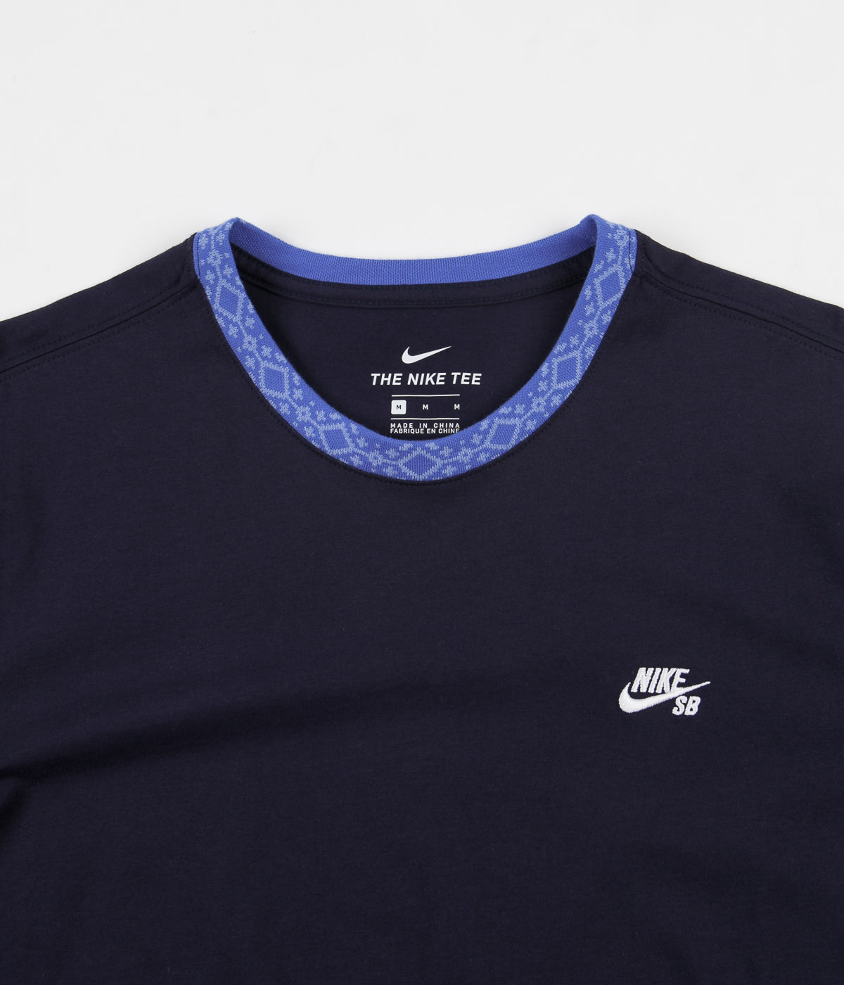 white nike shirt with blue logo