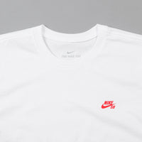 white nike shirt with red logo