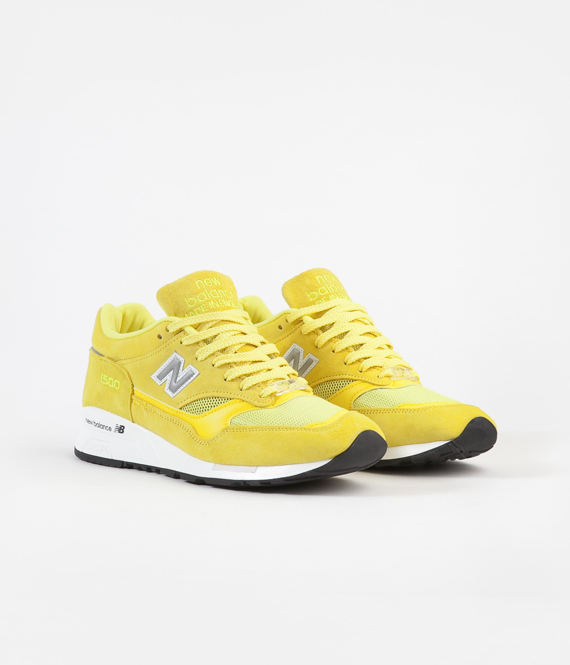 black and yellow new balance shoes