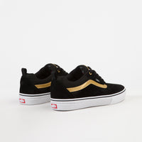 black vans with gold stripe