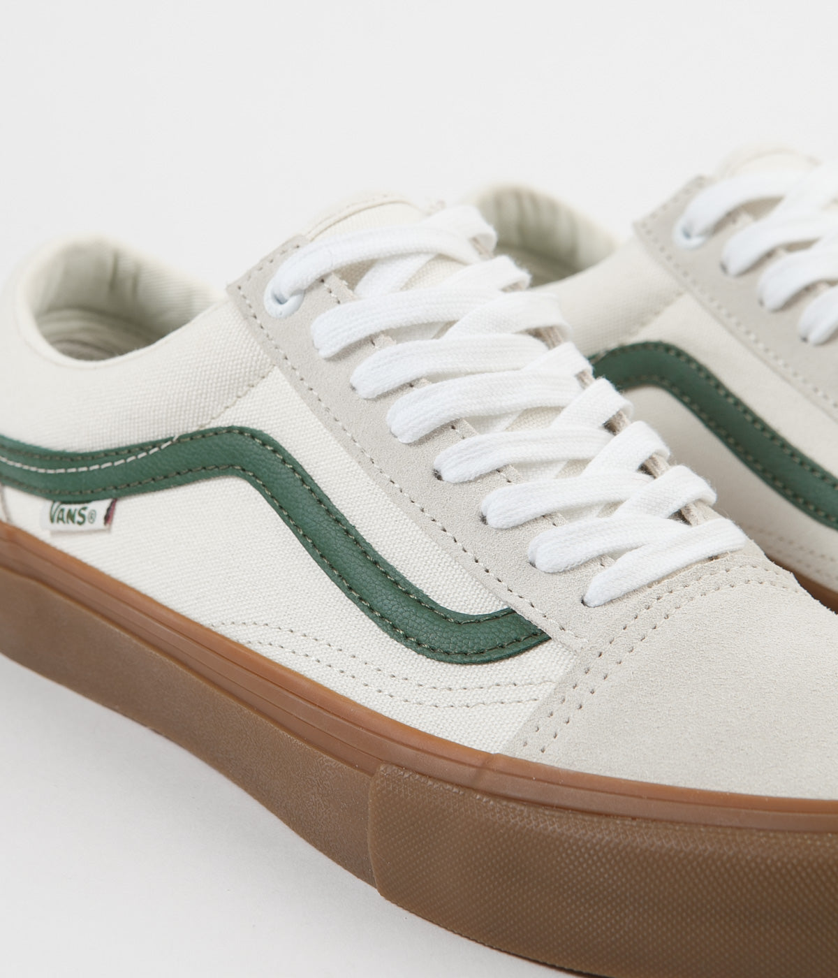 white old skool vans with green stripe