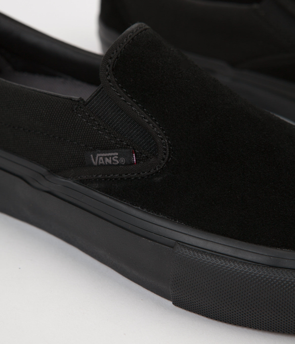 triple black slip on vans