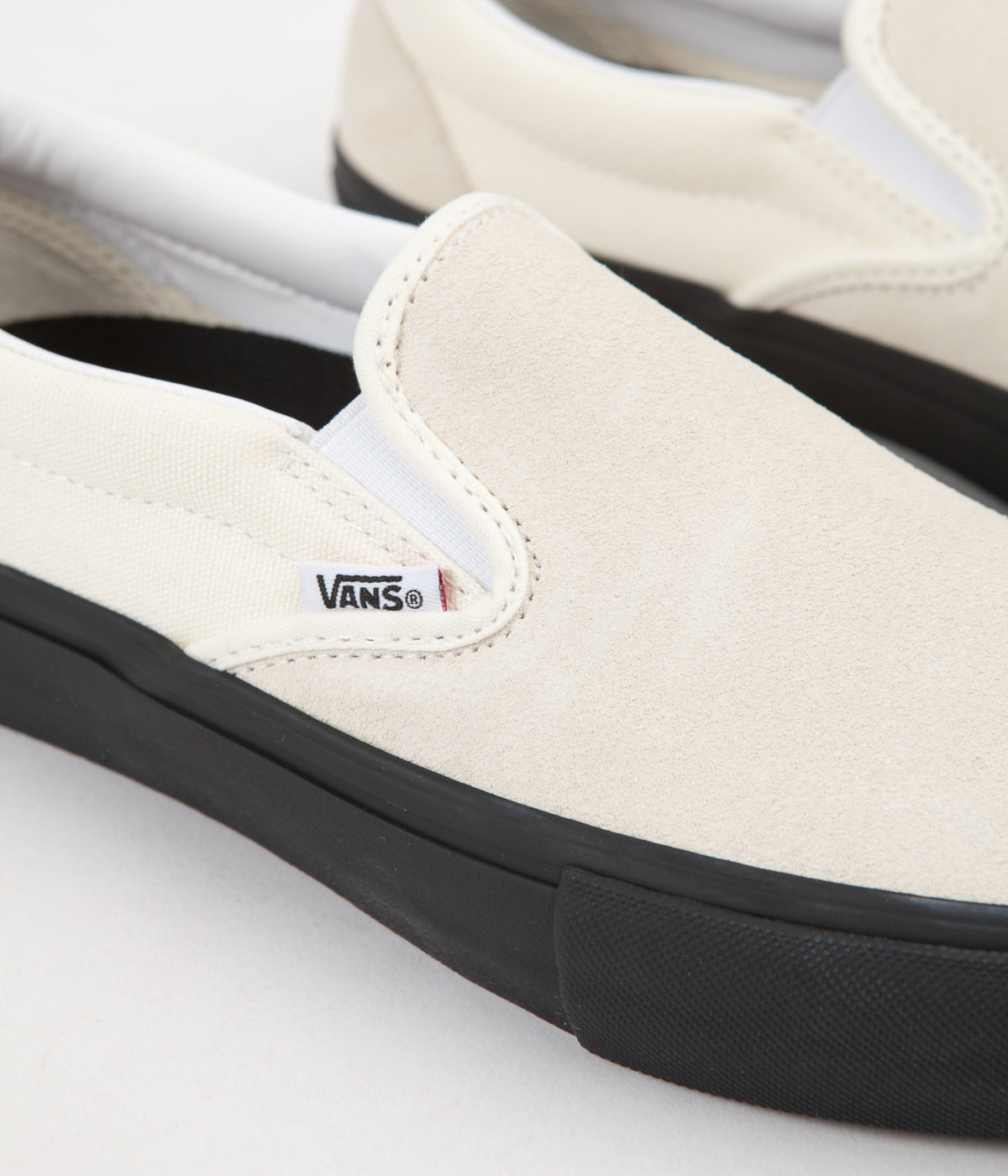 vans white and black slip on