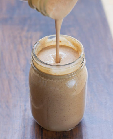 Mason jar being filled with Hazelnut Butter Banana Smoothie