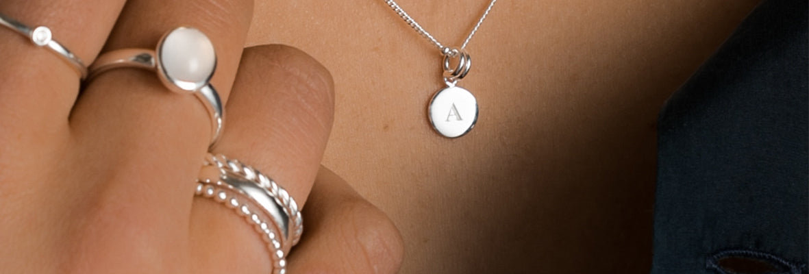 Image of silver rings worn on model, mood lighting