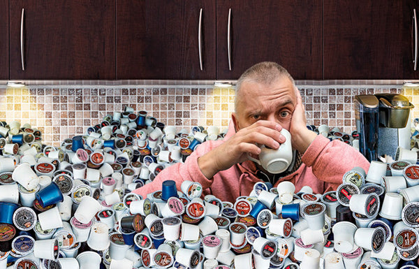 person surrounded by plastic coffee pods