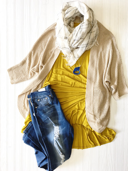gold dress worn with distressed jeans and cream cardigan