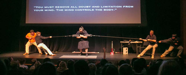 Dave Whitley - oldetime strongman wears utility kilt while performing feats of strength