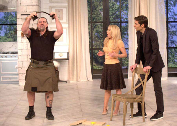 Iron Tamer Dave Whitley bends a pry bar for local TV morning show while wearing a utility kilt
