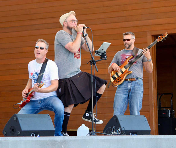 Rock band lead singer Jason Proulx performing a concert while wearing a utility kilt