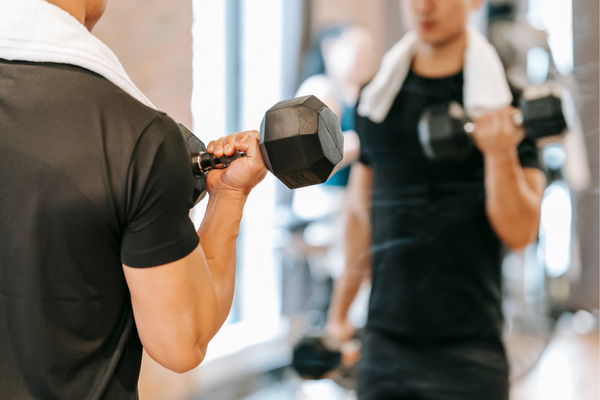 Man lifting weight in mirror