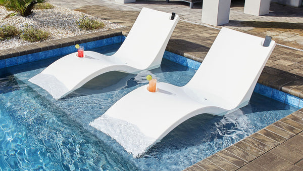 Two Kai Shelf loungers in a pool