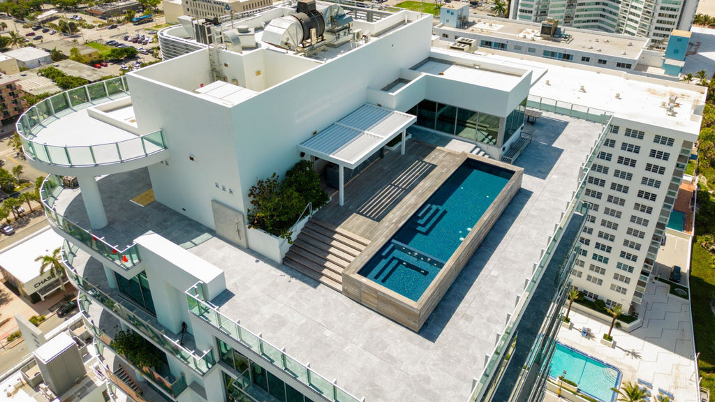 large, modern rooftop pool on top of luxury condos.