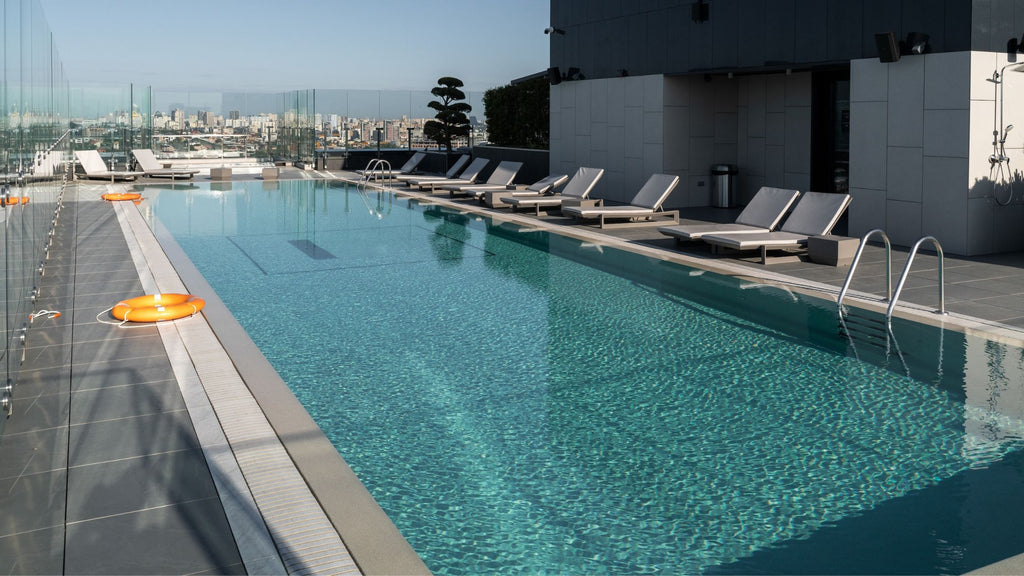 Beautiful modern, luxury rooftop pool with gray loungers.