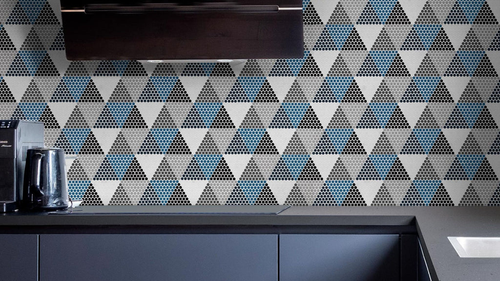 Small format hexagonal tile in white, dark blue, blue, dark gray, gray, light gray, and black, installed in triangle shapes creating a large geometric mosaic